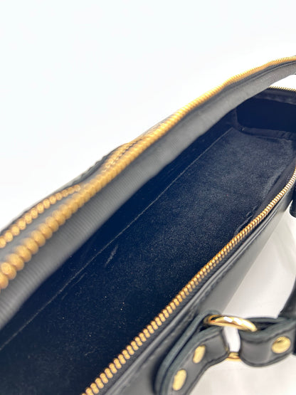Flute Bag - The black one with gold-toned materials.